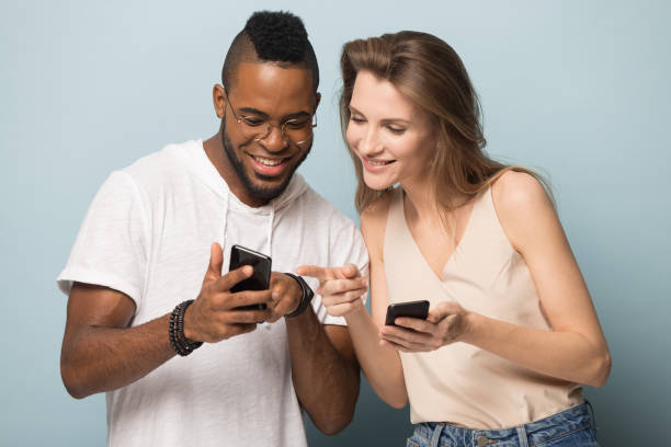 istock Smiling diverse people using cellphones in studio together 1262402854