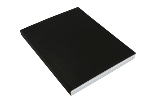 black soft back thick casebound book isolated on a white background