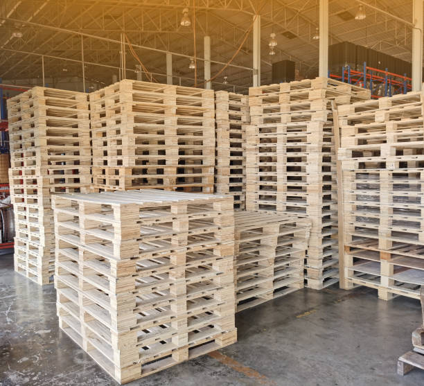 istock Wooden pallets stack at the freight cargo warehouse for transportation and logistics industrial 1262406222
