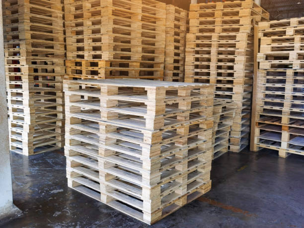 istock Wooden pallets stack at the freight cargo warehouse for transportation and logistics industrial 1262406229