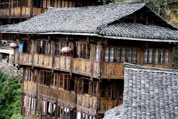 istock Multi-story wood house with shingled roof 1262409375