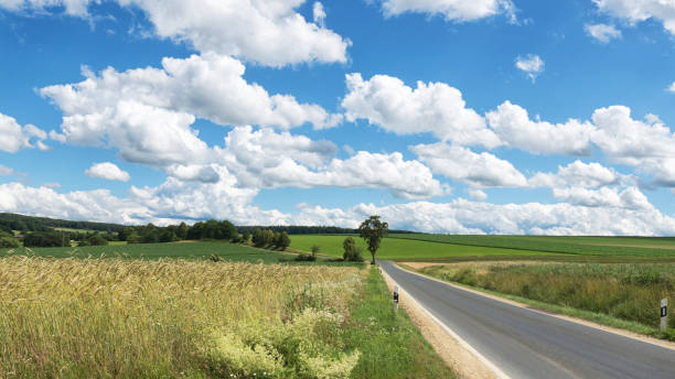 Impressive sky with cumulus clouds over a rural landscape with an asphalt road. Impressive sky with cumulus clouds over a rural landscape with an asphalt road.
Germany, Hesse near Kirtorf horizon over land stock pictures, royalty-free photos & images