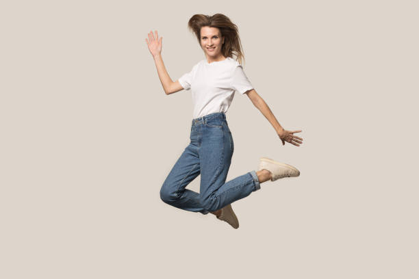 istock Active young woman jump high posing in studio 1262412447