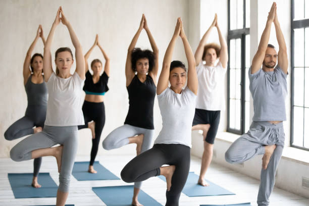 istock Young professional female indian ethnicity instructor leading yoga master class. 1262414034