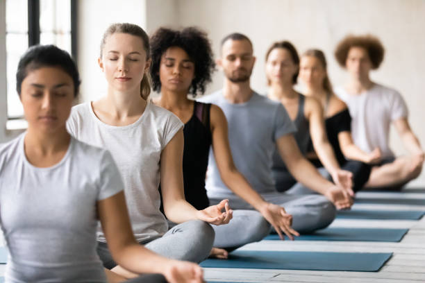 istock Mindful young mixed race people meditating indoors. 1262414093