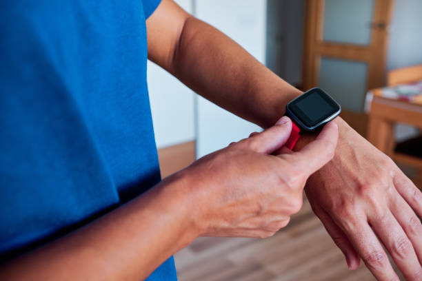 istock woman arm using smartwatch to control activity indoor 1262415574
