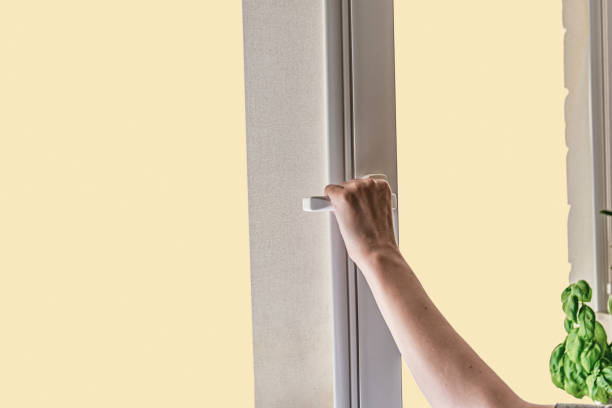 istock A woman's hand opens a window for airing room. window with curtain. 1262416822