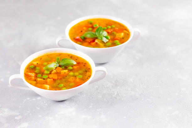 istock Vegetable soup with spices and basil on a light stone background. opy space. 1262419733