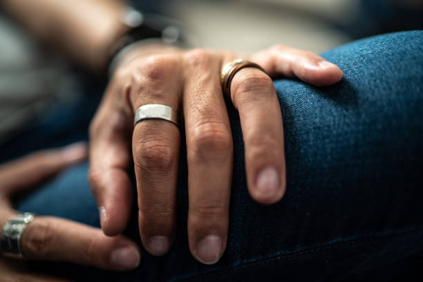 Close up in male hands with silver jewelry Close up in male hands with silver jewelry bijou personal accessory stock pictures, royalty-free photos & images