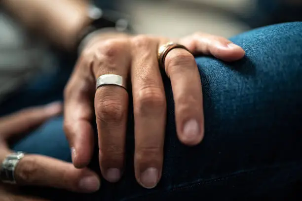 Close up in male hands with silver jewelry