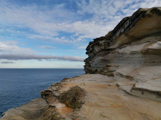 istock Beautiful coalstal trail with stunning rock formations and cliffs along the ocean front in the national park 1262423348