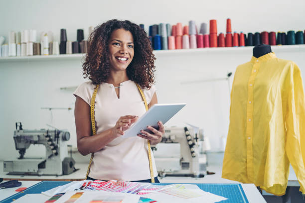 istock Smiling dressmaker holding a digital tablet in her atelier 1262424843