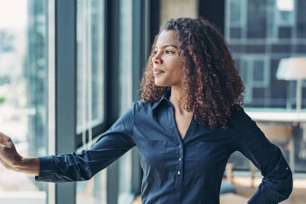 istock Young businesswoman looking through the window 1262424850