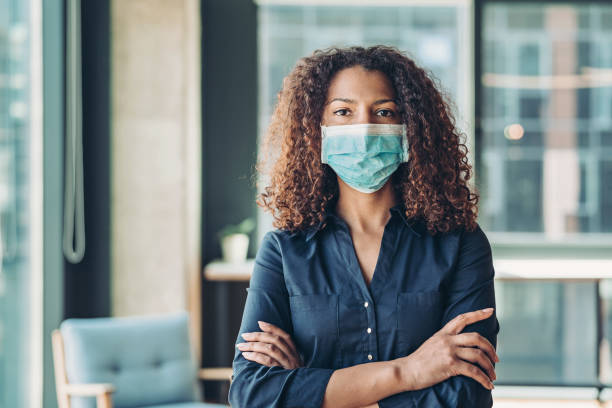 istock Serious businesswoman with a protective face mask 1262424852