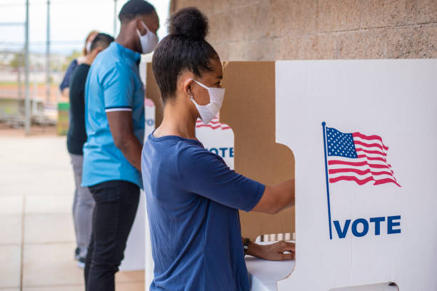 Voting Waiting in line and voting. democratic party usa stock pictures, royalty-free photos & images