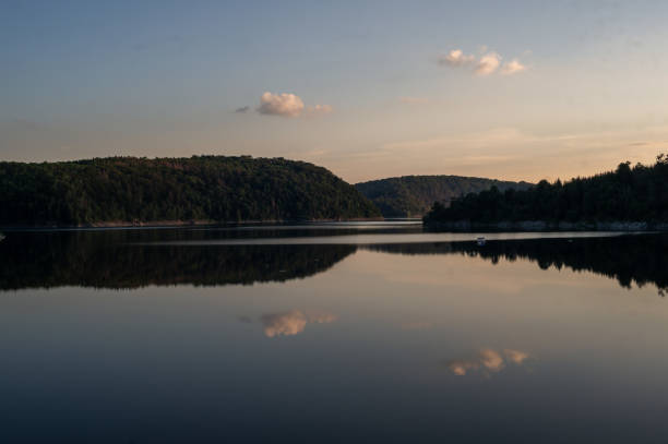 istock sunset over calm lake. mirroring clouds. Rappbodetalsperre, Harz, Germany 1262425018