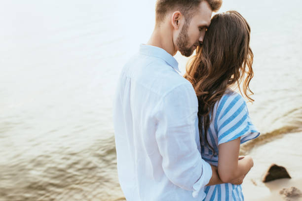 istock bearded man hugging girlfriend near lake 1262429544