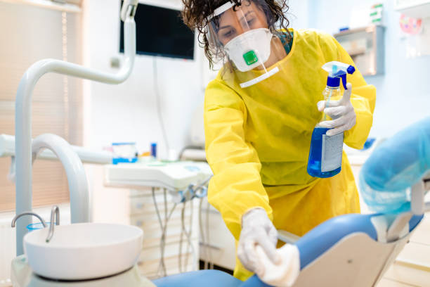 istock Diligent female dentist assistant make sure everything is clean and sterile for next patient 1262435056