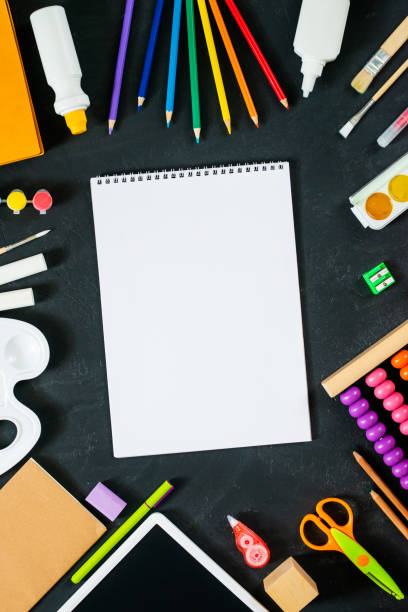 istock School supplies on black board background. Back to school concept. Frame, flatlay, copy space for text 1262436170