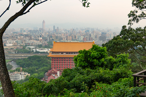 Modern building built with traditional style architecture, with Taipei city in the background