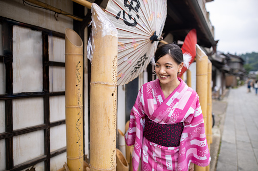 Young woman in yukata visiting Japanese summer bamboo festival