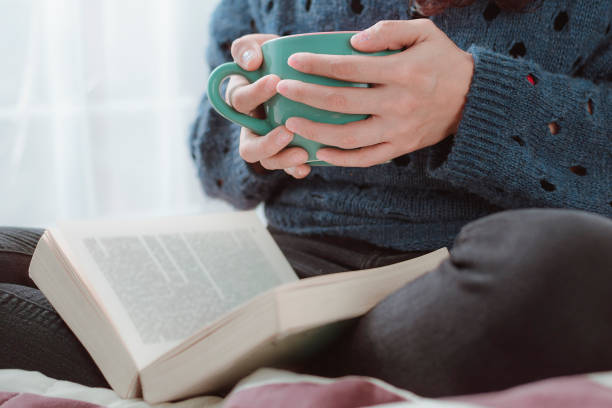 istock Reading a book with a cup of hot coffee 1262436629