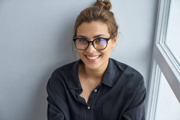 istock Cheerful pretty woman in spectacles at home 1262436678