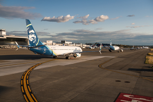 Seattle, USA - Sep 30 - 2019: Planes lined up in traffic waiting for their turn to take off at Seatac Airport Late in the day.