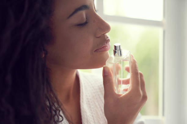 istock Calm pretty lady using fragrance at home 1262451317