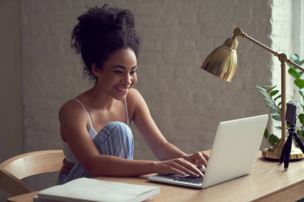 istock Cheerful young lady working with gadgets indoors online 1262460377