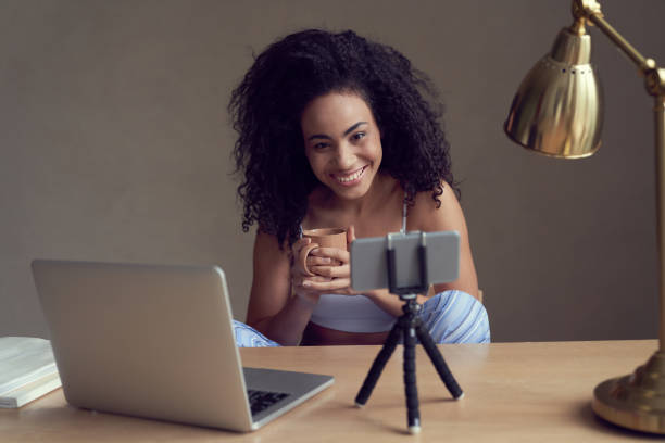 istock Jolly young woman using smartphone camera for communication 1262460380