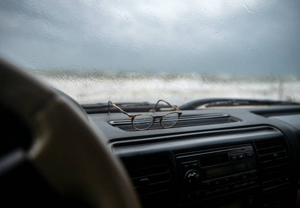 istock Glasses with rain drops on it on the car dashboard 1262472842