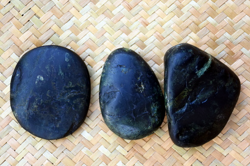A Collection of Fossicked Rough Pounamu or Greenstone.

Fossicking for Pounamu or Greenstone is a both a cultural and Kiwi activity in New Zealand. Pounamu or Greenstone are several types of hard and durable stone found in the South Island of New Zealand; such as Nephrite Jade, Bowenite, Serpentine, Argillite and Hydrogrossular Garnet. 

Pounamu is only found in the South Island of New Zealand giving the South Island its name 