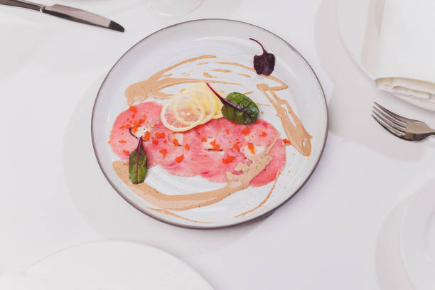 Smoked salmon and ingredients in plate on table