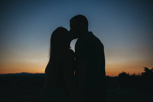 istock Sunset couple silhouette 1262491100