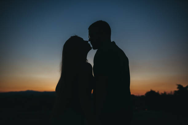 istock Sunset couple silhouette 1262491140