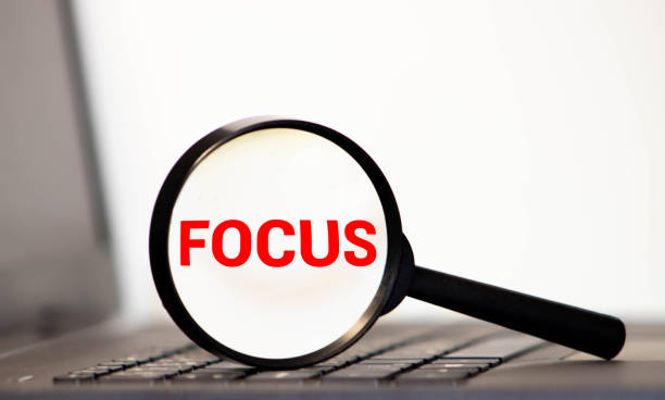istock Focus word through a magnifying glass. Magnifying glass search concept. Isolated on white background. 1262492066