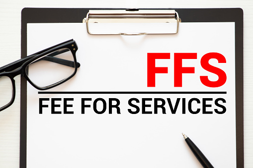 Concept image of Business Acronym FFS as Fee For Services written over road marking yellow paint line.