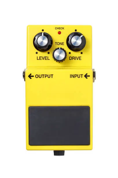 Stomp box electric guitar signal over drive yellow effects foot pedal isolated on white background with clipping path.