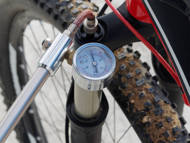 istock Pumping of the front, bicycle oil-air shock absorber using a specialized hand pump. Visible pressure. Top view. Active Lifestyle. 1262527426