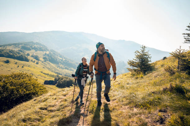 istock Young couple hiking in the mountains 1262542896
