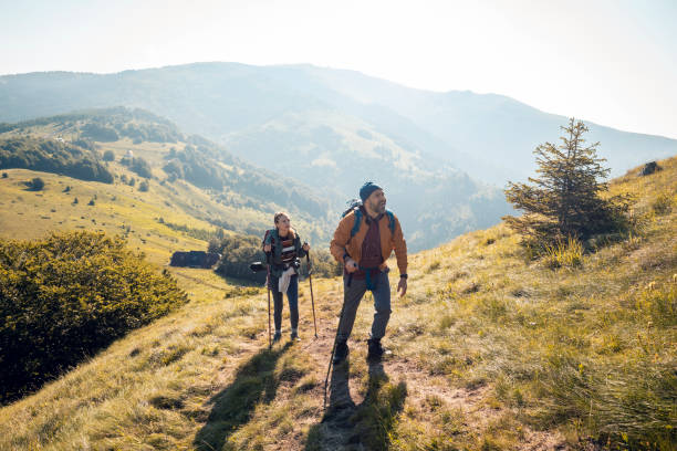 istock Young couple hiking in the mountains 1262542936