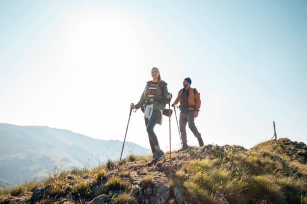 istock Young couple hiking in the mountains 1262543984
