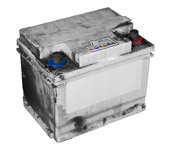 Dirty old car battery isolated on white stock photo