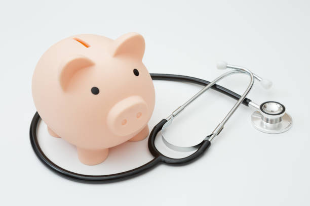 istock Stethoscope and piggy bank on white background 1262554015
