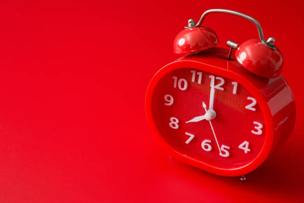 istock red alarm clock on a red background and copy space 1262554030