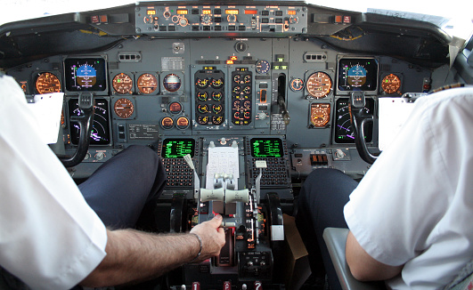 Aircraft Cockpit Boeing 737 prior to take off. Captain and first officer run through a pre flight check. Note the 
