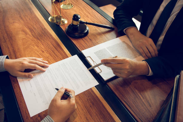 istock Lawyer is explaining about the wrongdoing laws regarding fraud to the client at the office. 1262558918