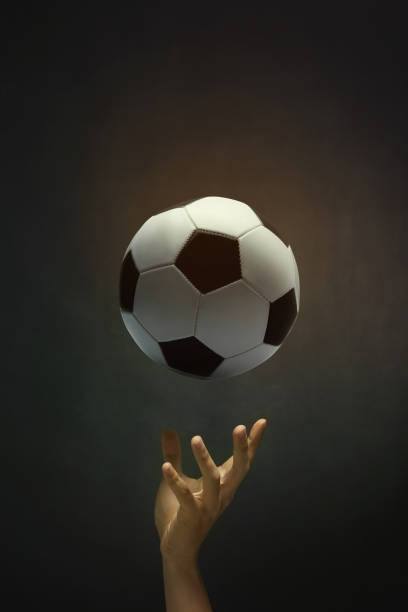 istock Soccer ball with hand 1262558993
