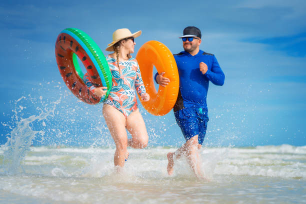 istock Young hispanic couple running on a Florida beach 1262563124